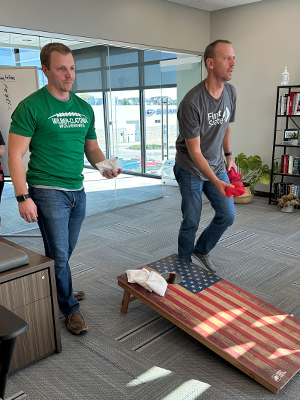 Employees playing cornhole